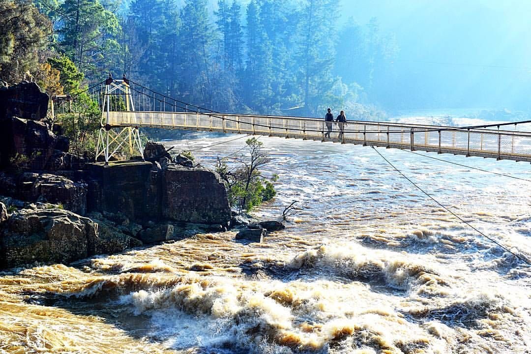 High river flows beneath Alexandra Suspension Bridge at Cataract Gorge