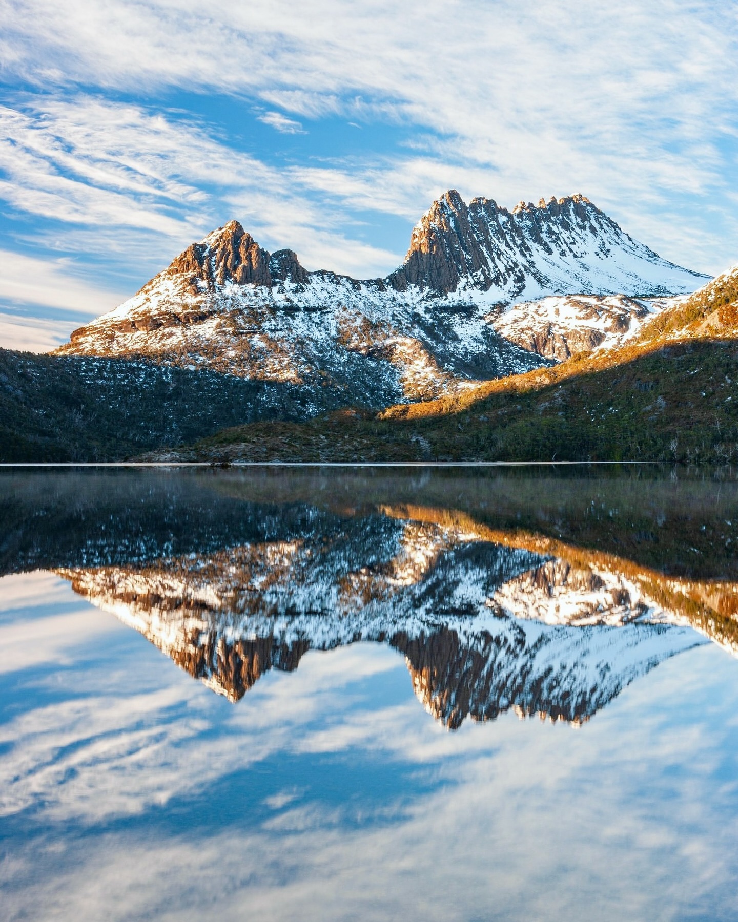 Snow-covered Cradle Mountain reflected in Dove Lake