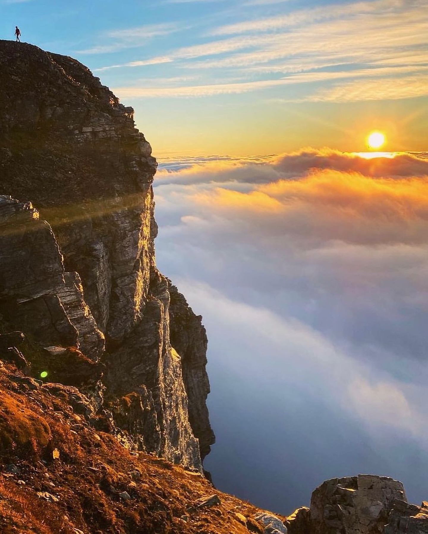 Frenchmans Cap rising above cloud at sunrise
