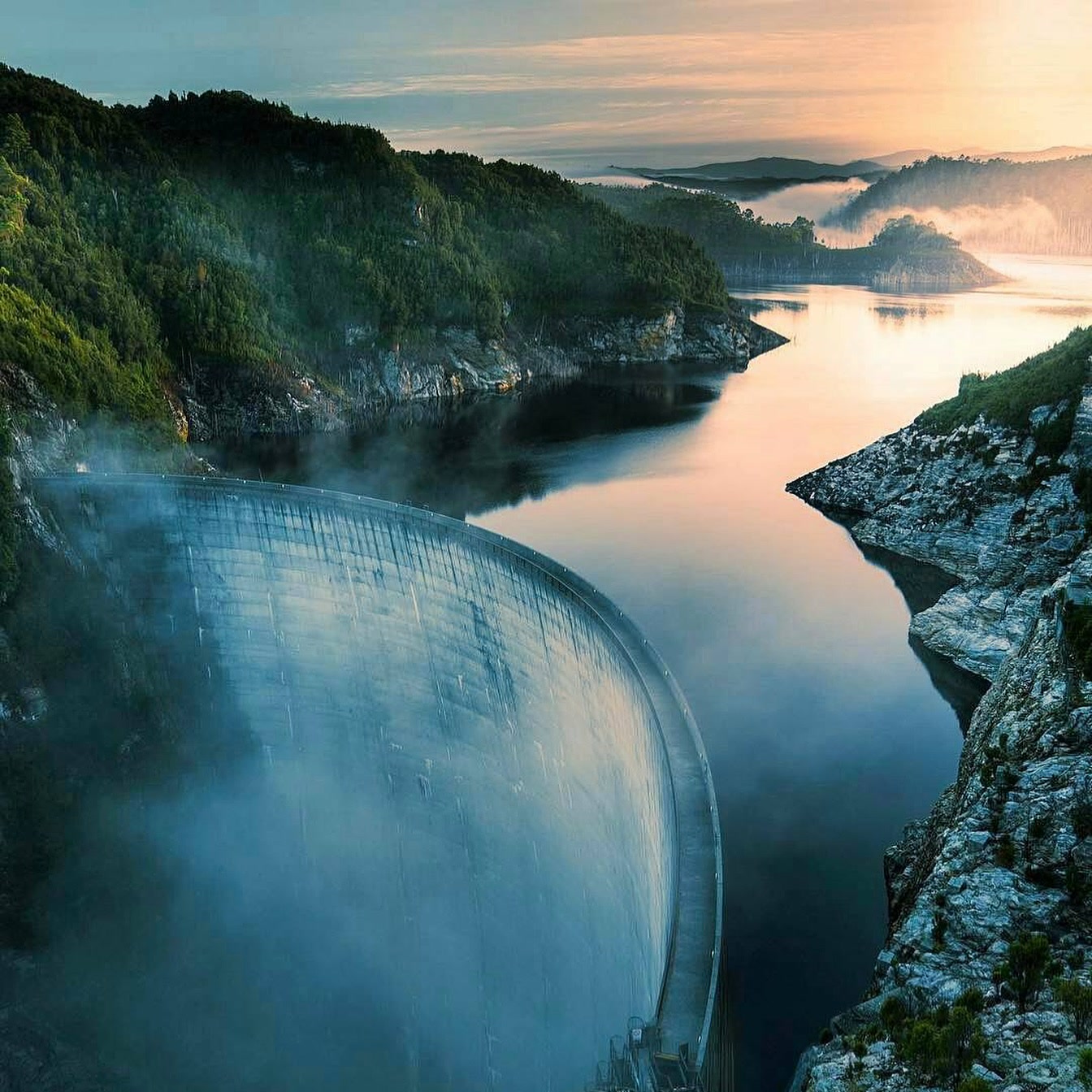 Gordon Dam curving across the Gordon Gorge at sunrise