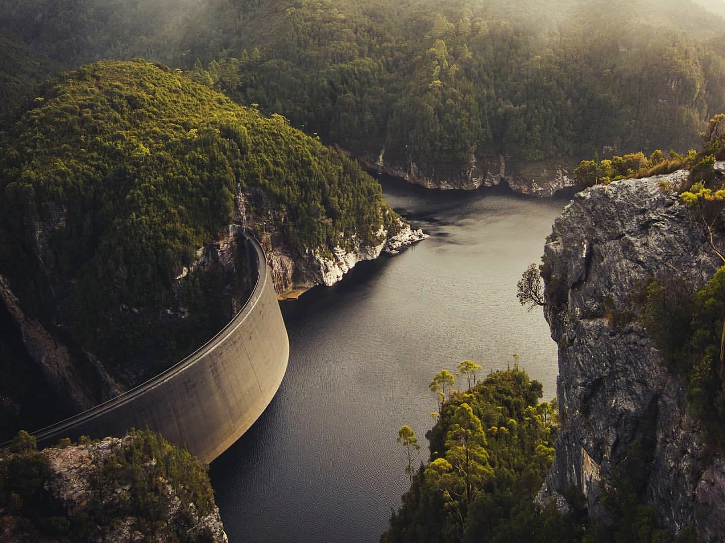 Gordon Dam curving between steep forested cliffs in Tasmania's south-west