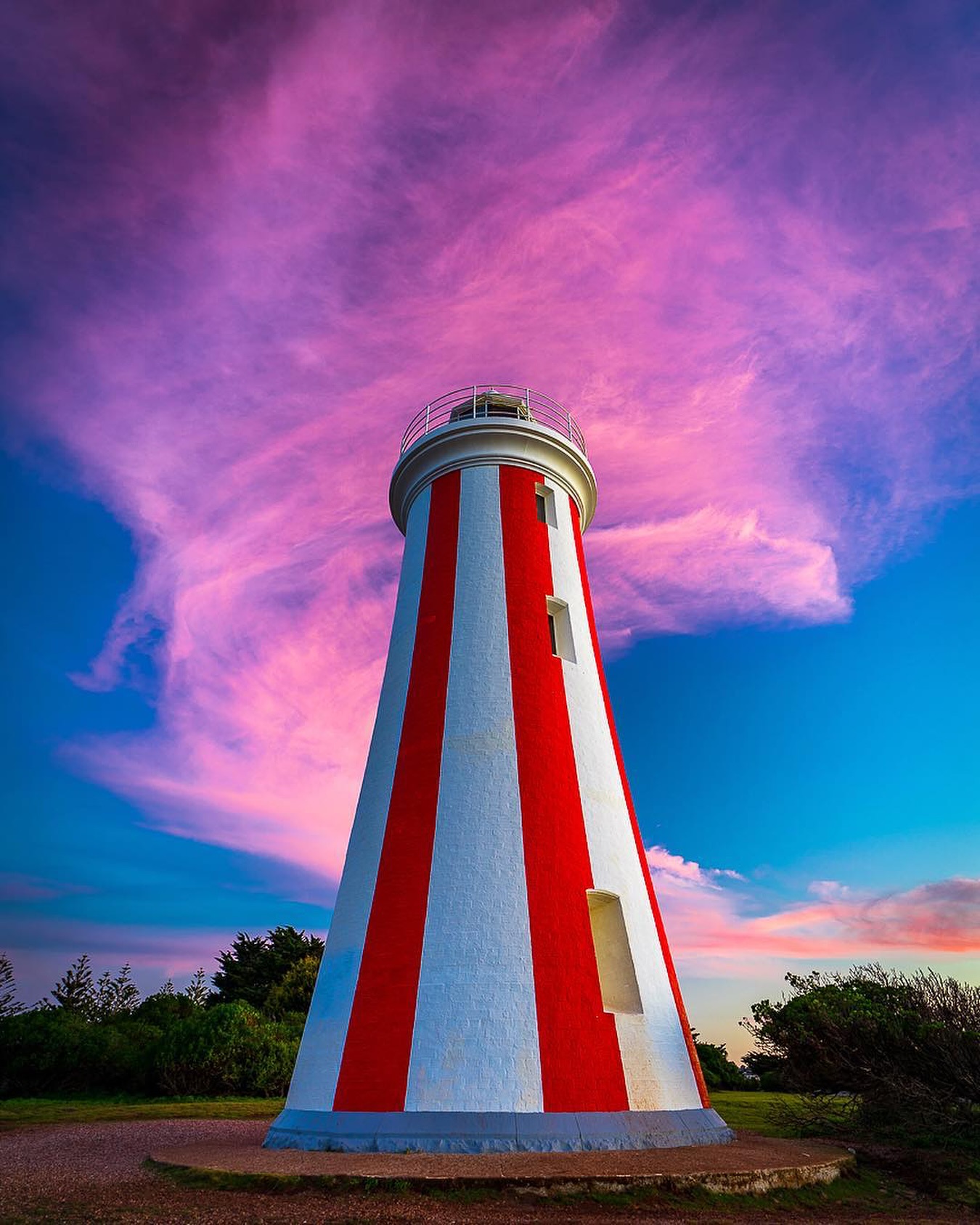 Red and white Mersey Bluff Lighthouse above the coast at Devonport
