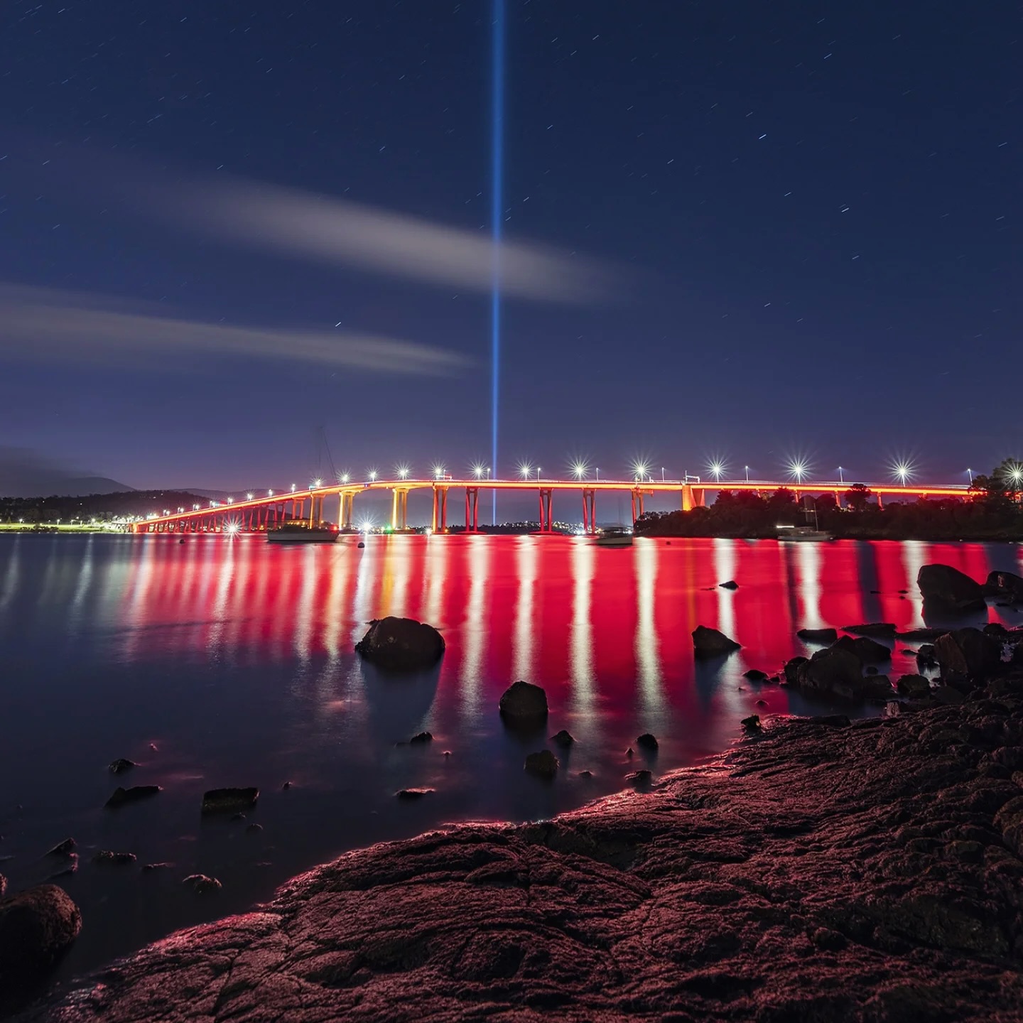 Tasman Bridge illuminated red during Dark Mofo above the River Derwent